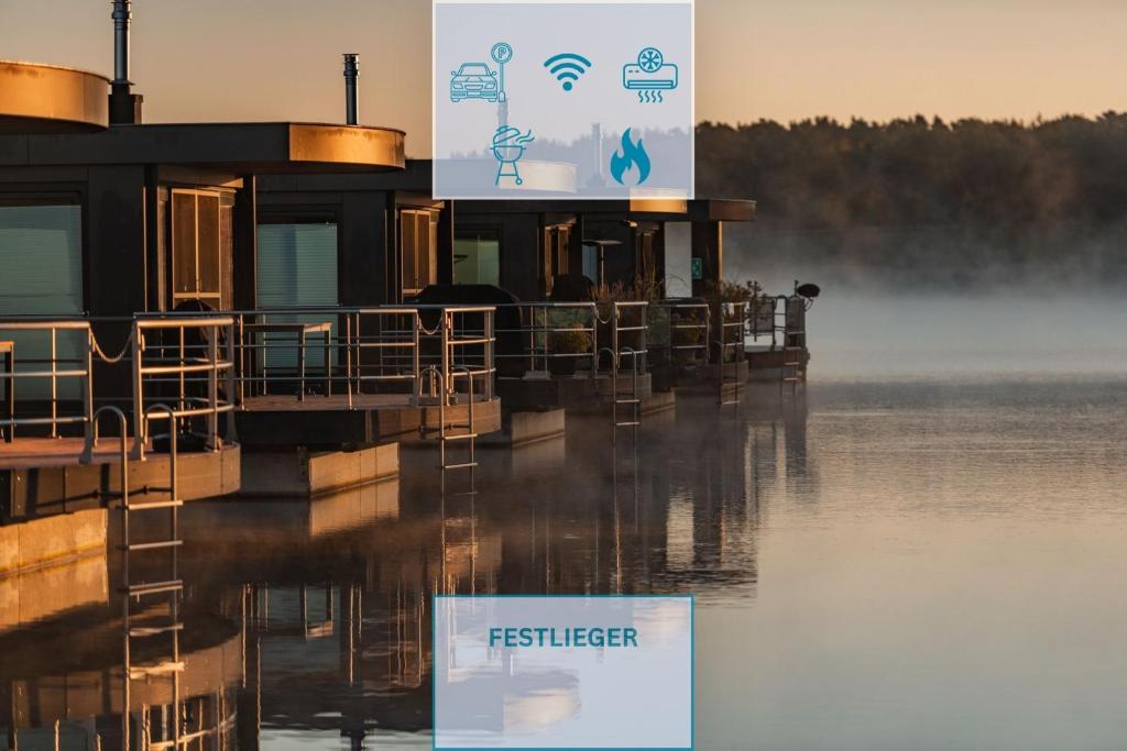 a restaurant on the water with a sign on it at Floatinghouse Malibu Sunrise in Klitten