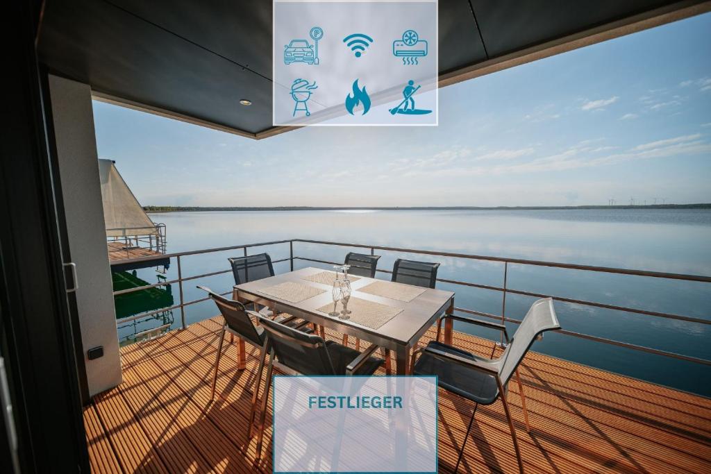a table and chairs on the deck of a boat at Floatinghouse Queen - LP6 in Vetschau