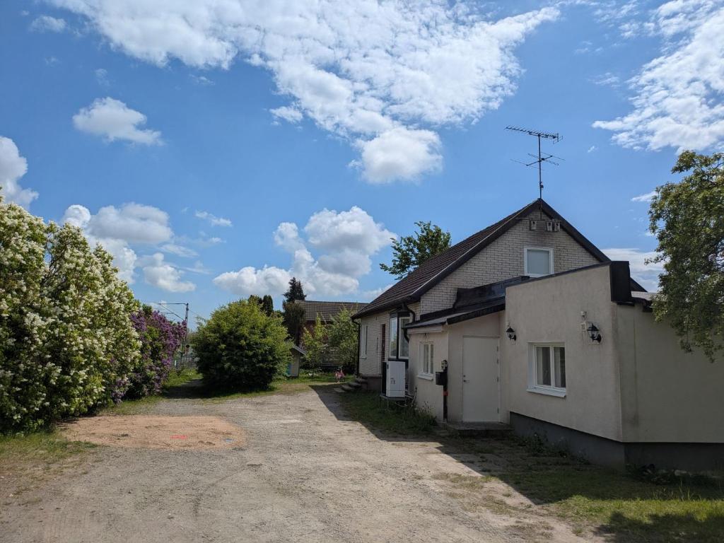 a house with a driveway next to a building at A charming countryside accommodation near Malm in Oxie