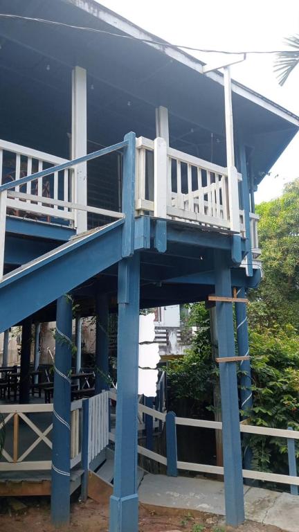 a house with a blue and white deck on it at LOTO'S House in West End