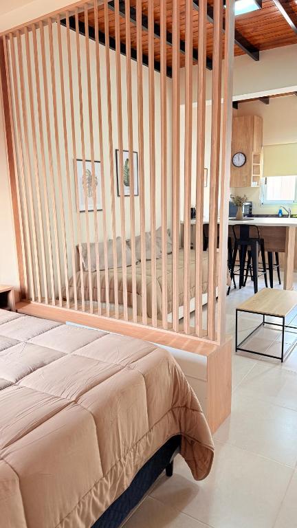 a bedroom with a bed with a wooden headboard at Apart Zona Paula in San Juan