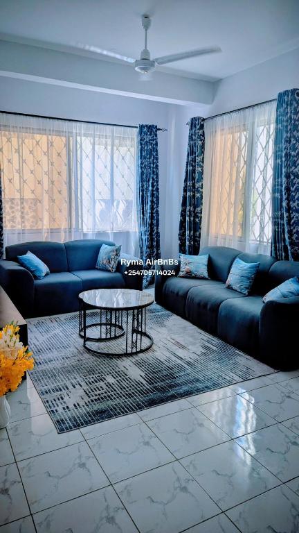 a living room with a couch and a table at Ryma Airbnbs in Mombasa