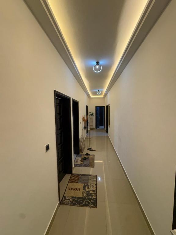 a hallway with white walls and a ceiling at La Kribienne in Cotonou