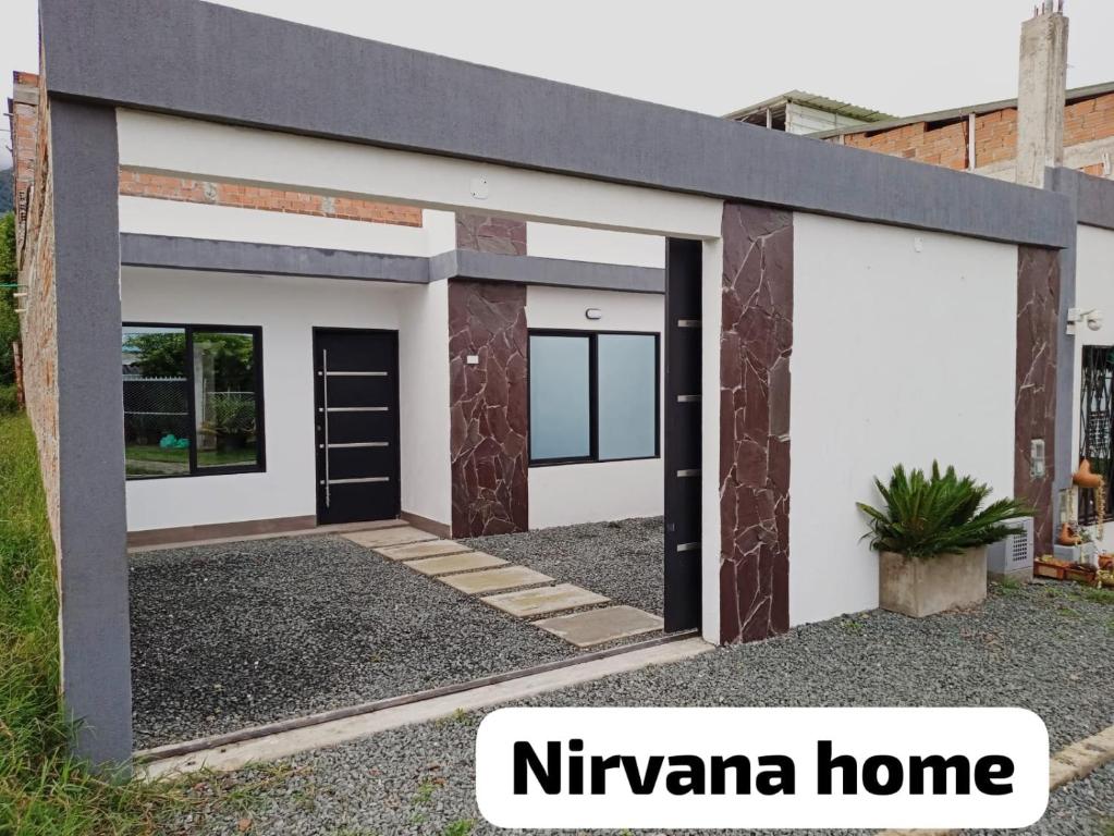 a contemporary home with a white and black garage at Nirvana Home Calima Darien in Darién