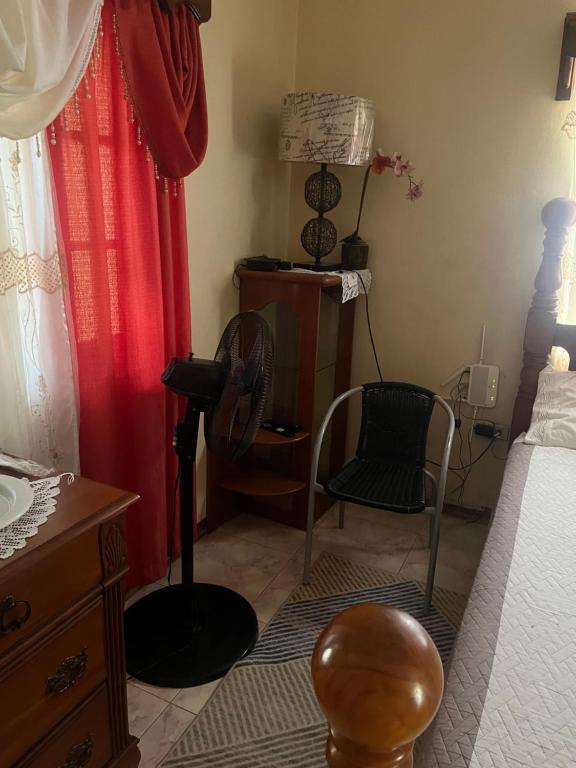 a bedroom with a bed and a desk and a chair at Driftwood Suite in Runaway Bay