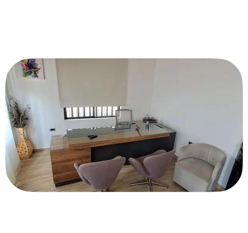 a bathroom with a sink and two chairs in a room at Casa totalmente amoblada in Yopal