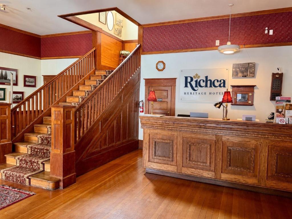 eine Lobby eines Gebäudes mit einem Treppenhaus und einem Räuber in der Unterkunft Richca Heritage Hotel in Chilliwack