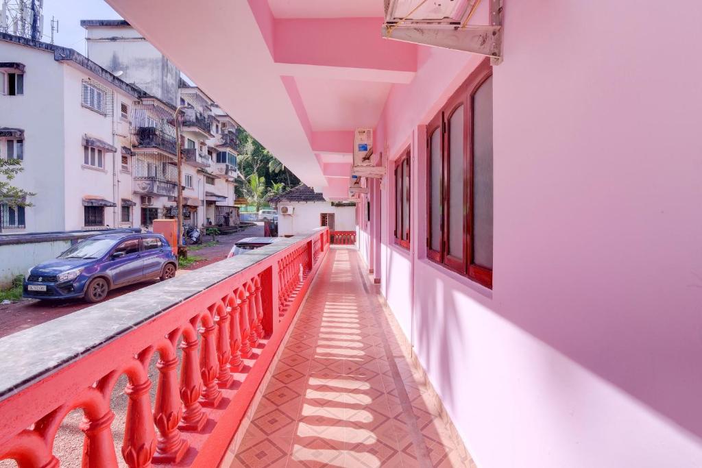 a balcony of a building with a red railing at Hotel O Omkar Guest House Near Immaculate Conception Church in Panaji