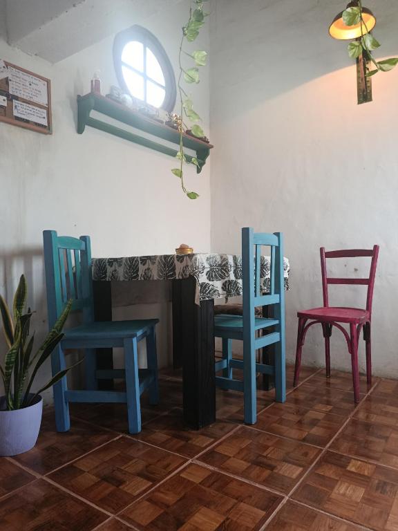 a table and chairs in a room with a table and two chairs at La esquina in Olavarría