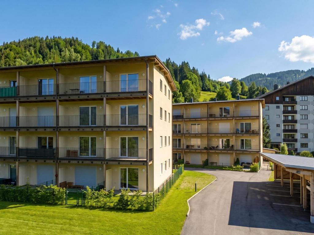 an apartment building in the mountains with a yard at Mariazeller Zirbennest in Mariazell