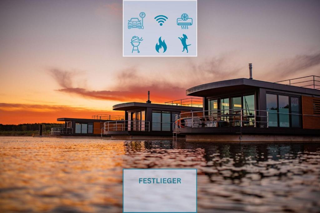 a group of houses on the water at sunset at Floatinghouse Hideaway LP26 in Klitten