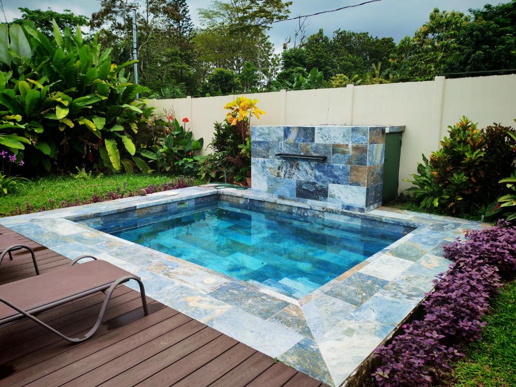 a swimming pool with a fireplace in a backyard at Lisa Loft Boutique Apartment in Fortuna
