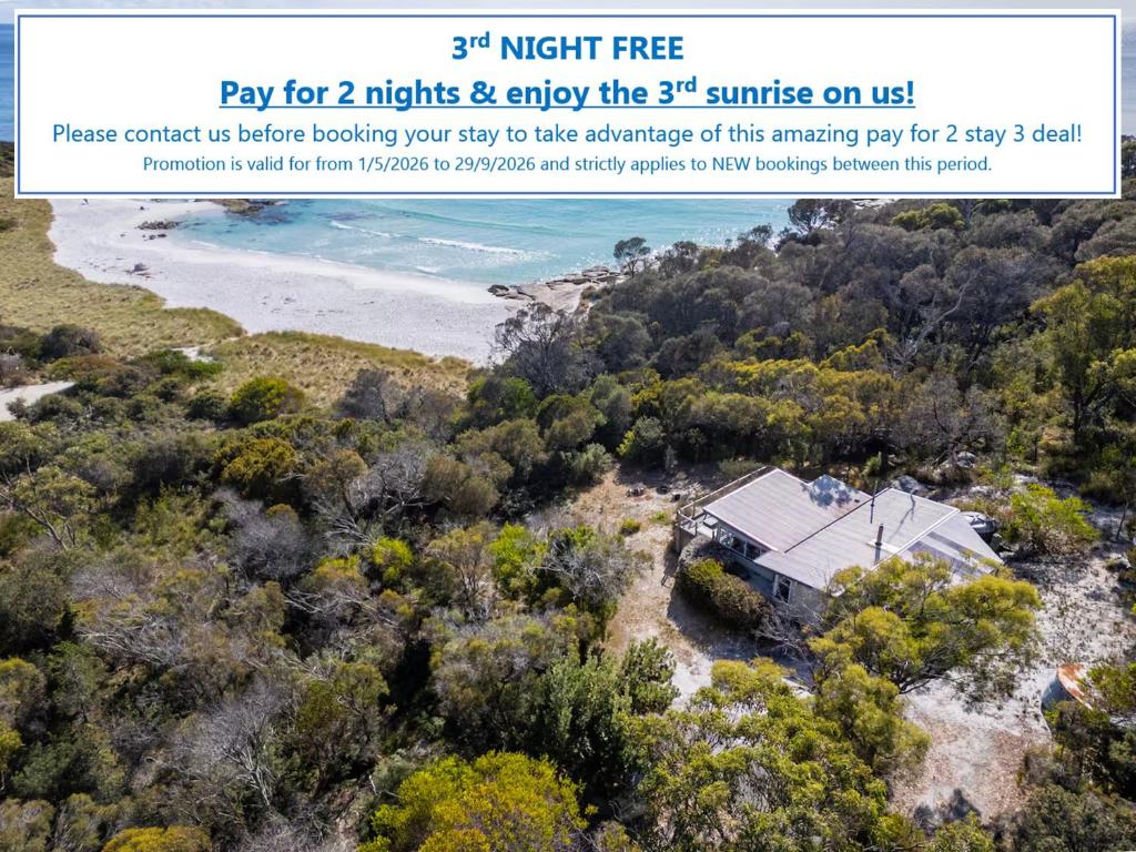 an image of a house on a hill next to a beach at The Shack - Beachside At Binalong in Binalong Bay