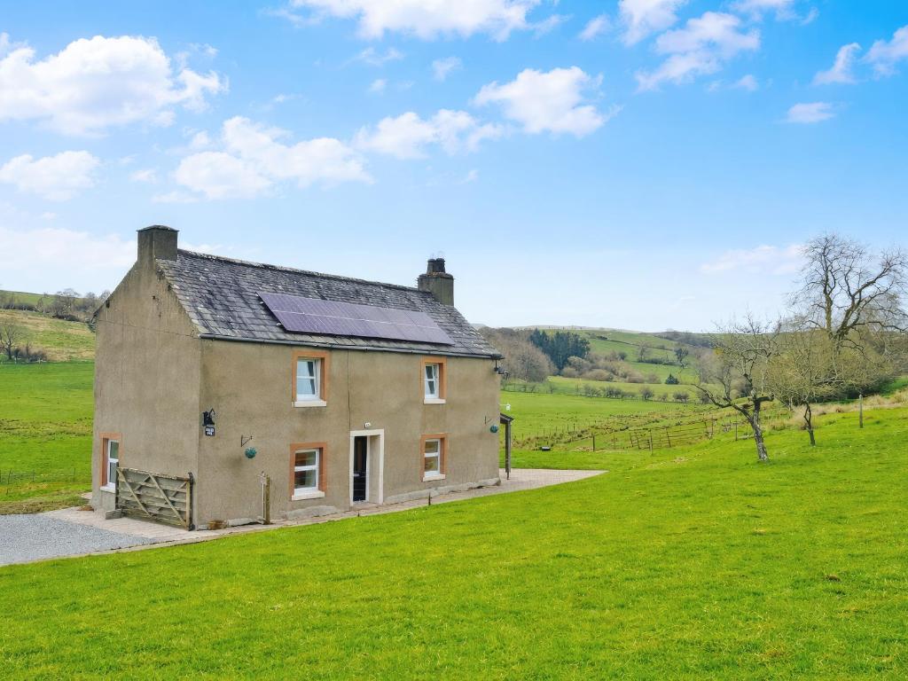 a house with a solar roof on a green field at High Park House in Brough
