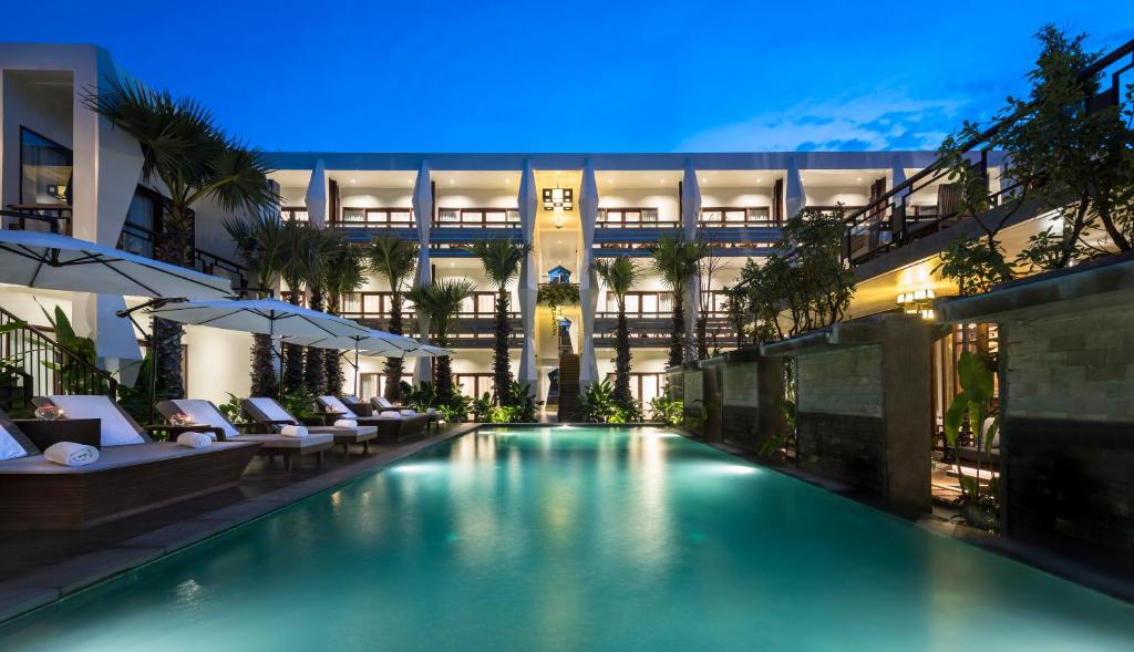 a swimming pool in the middle of a building at Jaya House River Park in Siem Reap