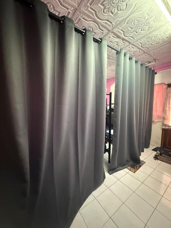 a row of gray curtains in a room at Pink Hostel in Ko Tao