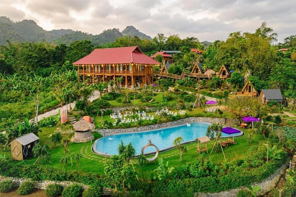 an aerial view of a resort with a swimming pool at Mây farmstay in Ðà Bắc