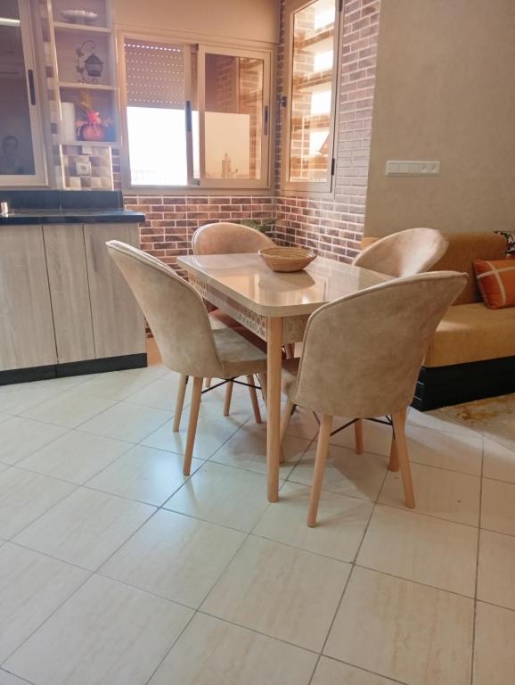 a dining room table and chairs in a kitchen at Cozy and Comfortable Apartment in Agadir