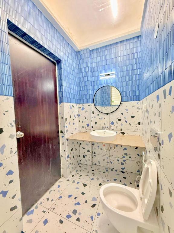 a bathroom with a toilet and a sink at Sunset havan villa in Lonavala