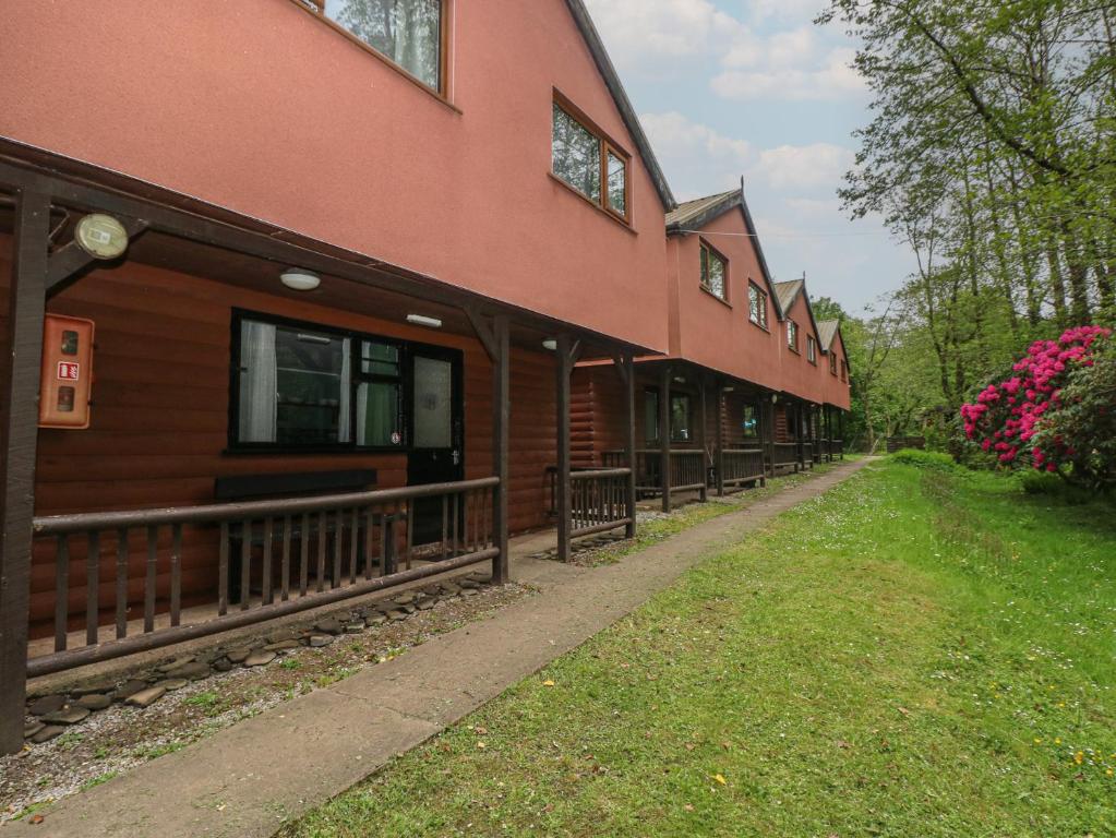 a building with a walkway in front of it at Cabin No 3 - Salt and Fern Cabins in Port Talbot