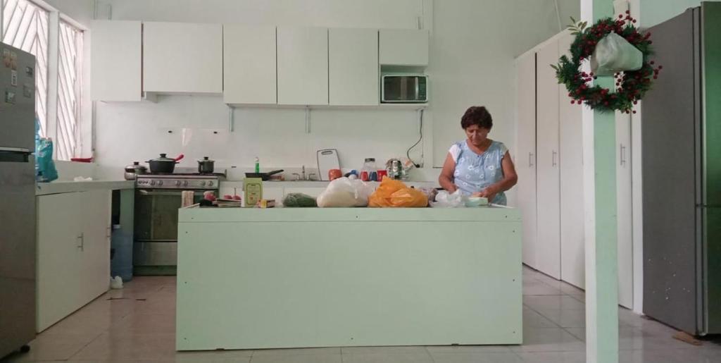 a woman standing at a counter in a kitchen at Jakcqueline in Pucallpa