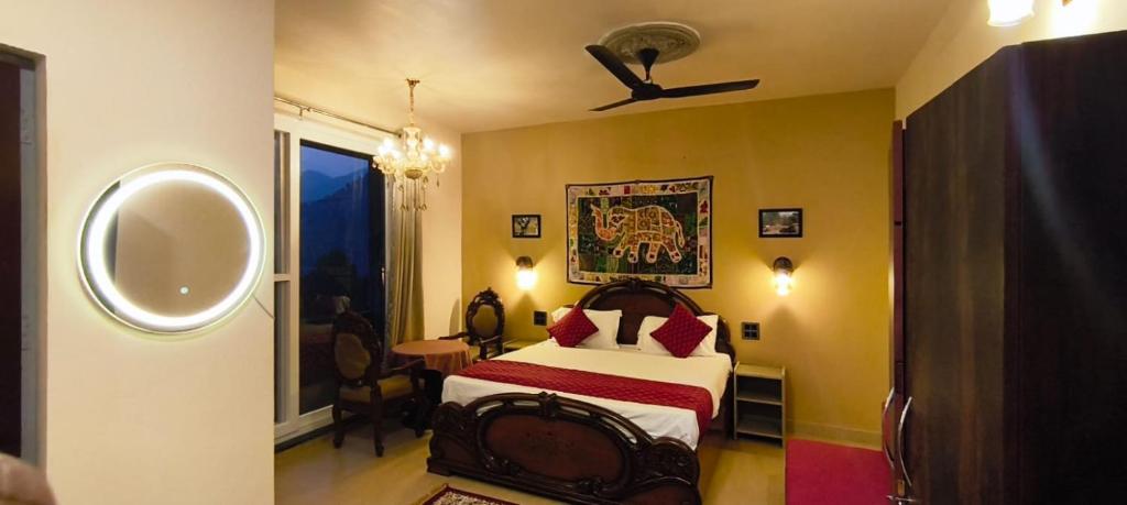 a hotel room with a bed and a window at The Stone Hamlet Retreat in Barkot