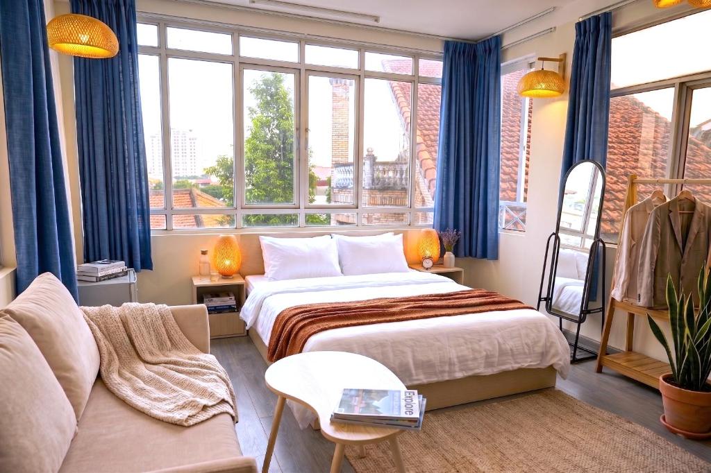 a hotel room with a bed and a couch at Four Seasons Serenity Studio - SDhousing branch in Hanoi