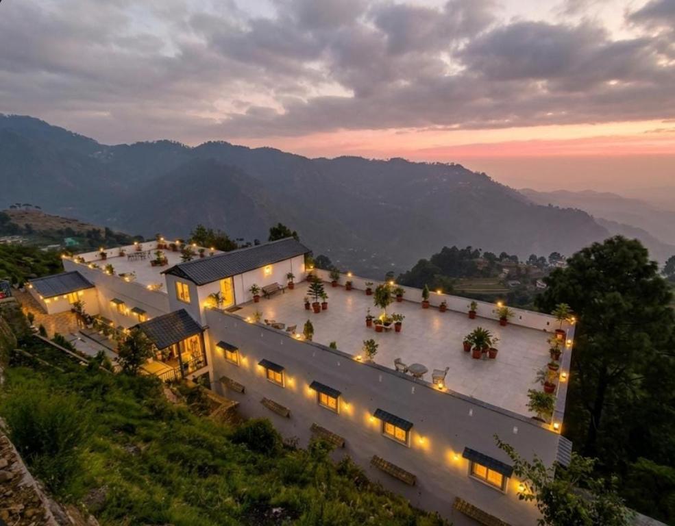 an aerial view of a large building with lights at Serene Forest Resort in Nainital
