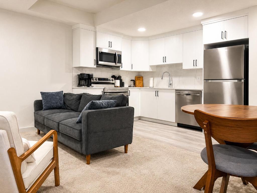 a living room with a couch and a table at Modern 2BR Private Suite in SW Calgary in Calgary