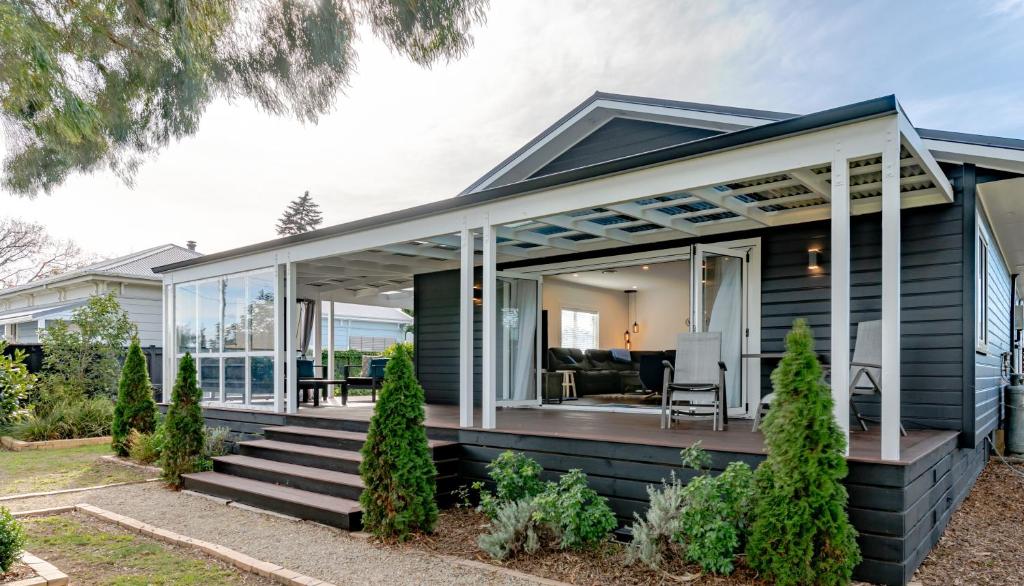 a house with glass doors and a porch at 19 Broadway in Martinborough