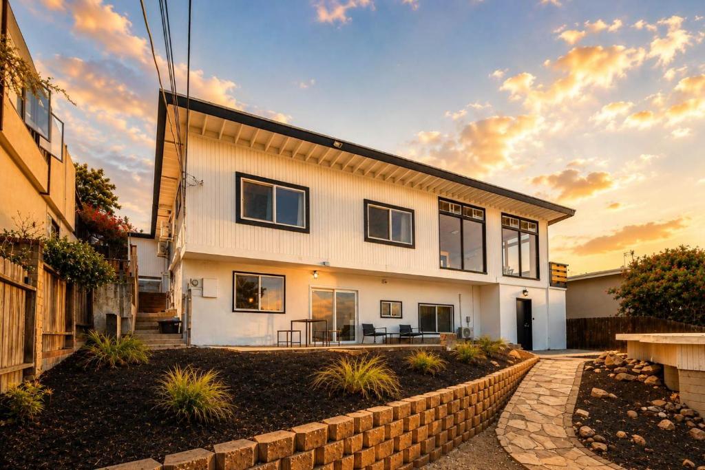 a large white house with a brick wall at 2Homes Villa Renovated Views in La Mesa
