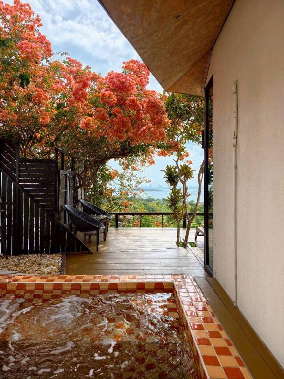 a view of a garden from the outside of a house at Baan Sahai Tone บ้านสหายโทน in Ko Larn