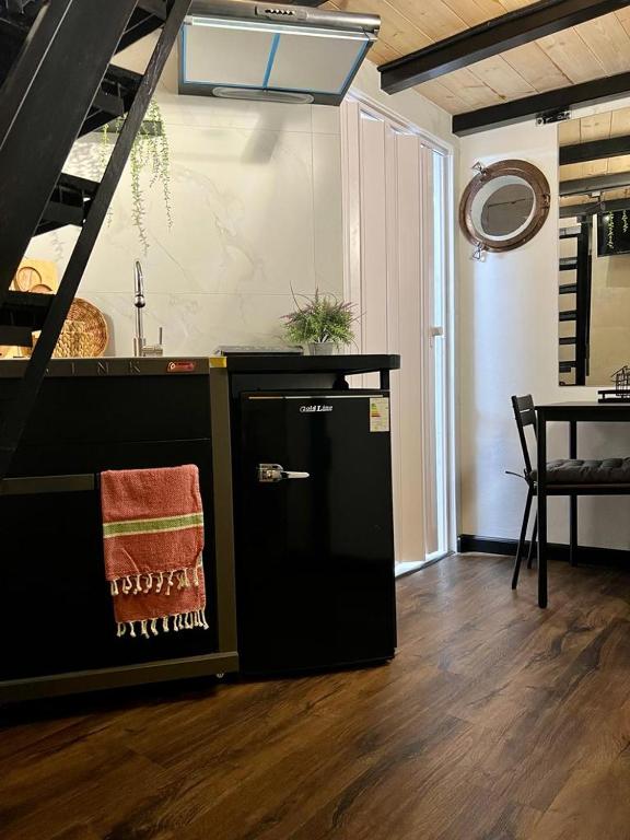 a kitchen with a counter and a table with a sink at A corner by the sea in Ashdod