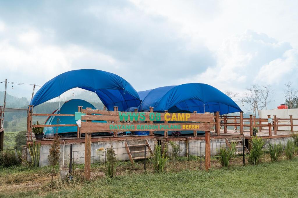two blue umbrellas on top of a wooden bench at WWS Cabin By ARBA in Palayangan