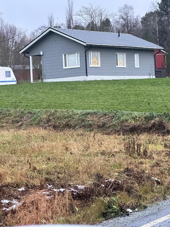 a house with a field of grass in front of it at Peaceful Comfort in Suni