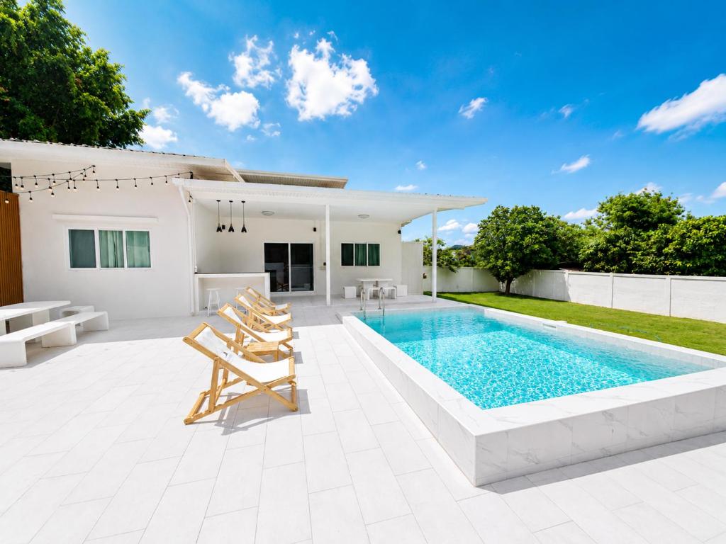 a swimming pool in the backyard of a house at The paperwhite poolvilla khaoyai in Ban Tha Chang