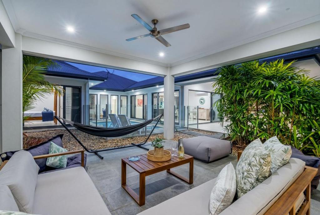 a living room with a hammock in a house at Belle Escapes Castaways in Palm Cove