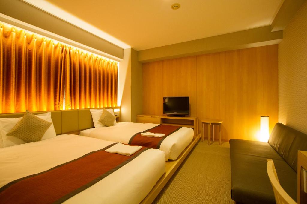 Postel nebo postele na pokoji v ubytování Hotel Sunroute Asakusa