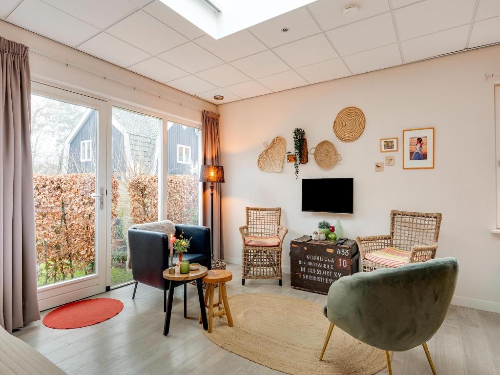 a living room with two chairs and a tv at Alluring Apartment in Bergen with Terrace, Garden and BBQ in Bergen