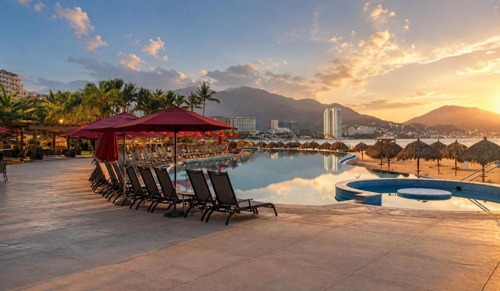 a pool with chairs and umbrellas in a resort at Grand Venetian Comfort in Puerto Vallarta