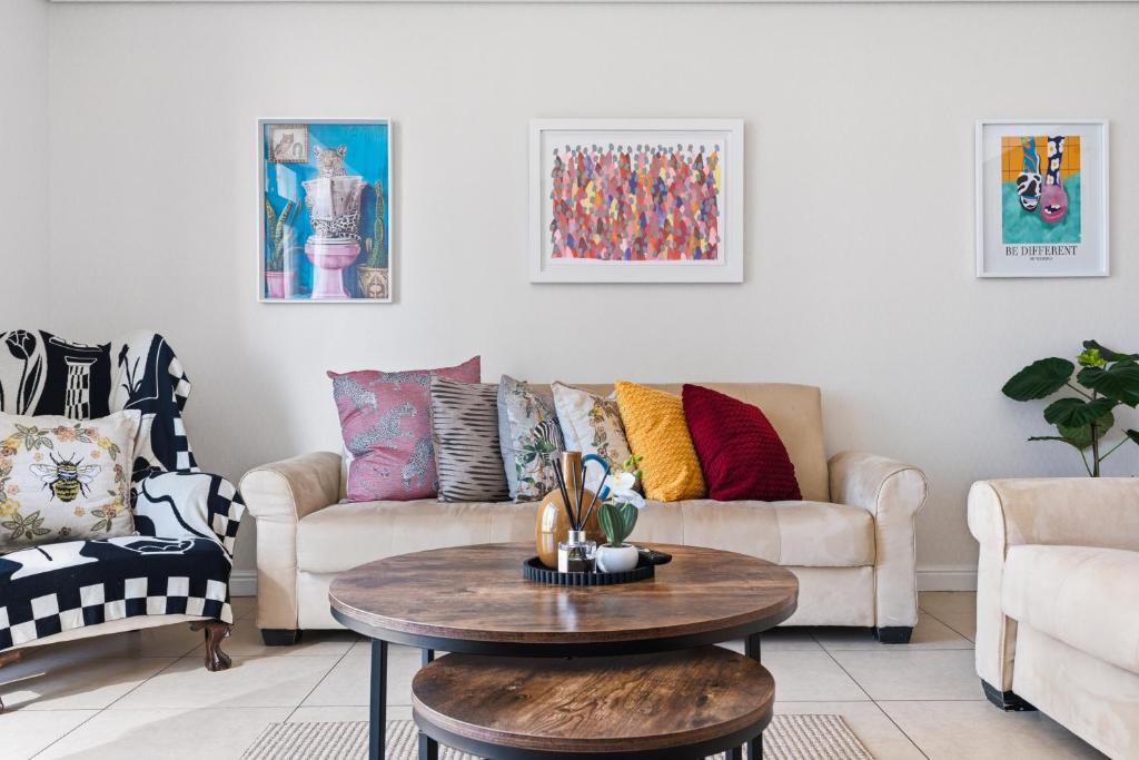 a living room with a couch and a table at Built on Hope De Waterkant in Cape Town