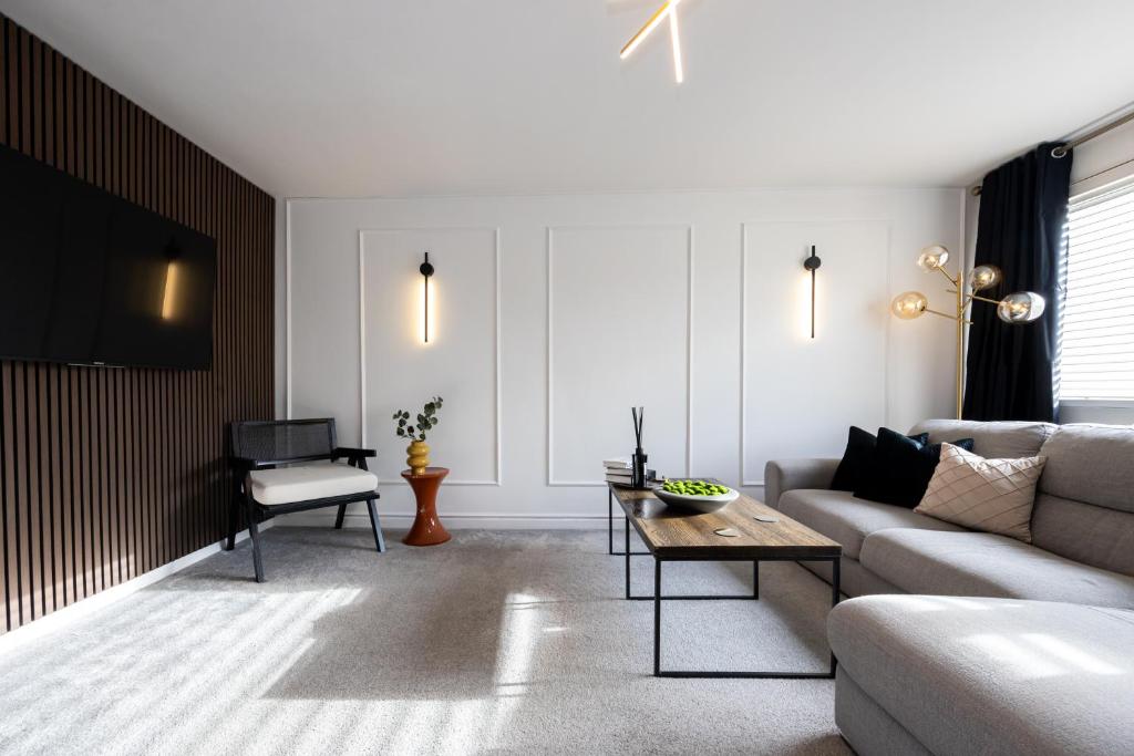 a living room with a couch and a table at Peaceful hideaway with homely comforts in Timperley
