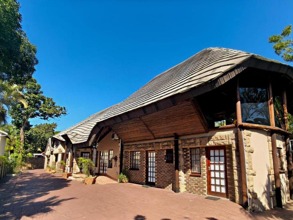 a building with a gambrel roof on top of it at Forest Lodge - Richards Bay in Richards Bay