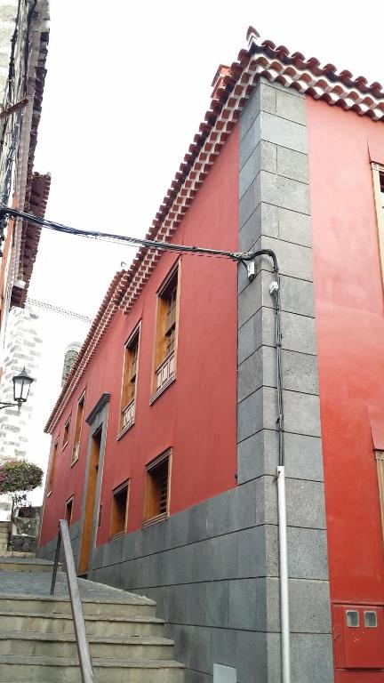 a red building with stairs in front of it at La Bouganvilla in Garachico