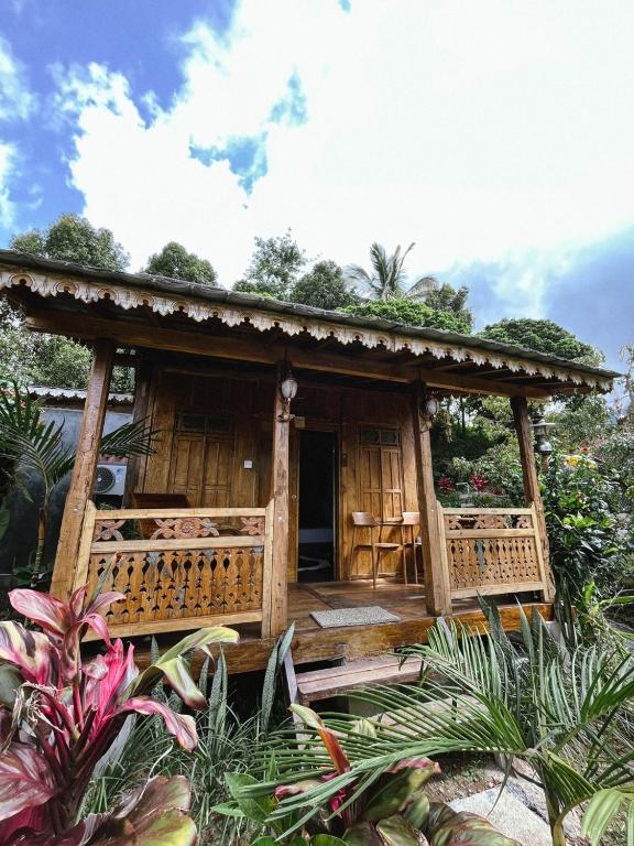 a small house with a porch in a garden at Bali Hidden Lemukih in Sawan
