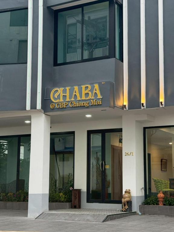a building with a dog standing in front of it at Chaba CBP Chiang Mai in Chiang Mai