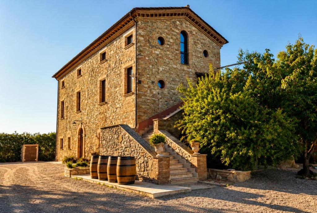 a large brick building with a staircase in front of it at Casale Torresquadrata in Todi