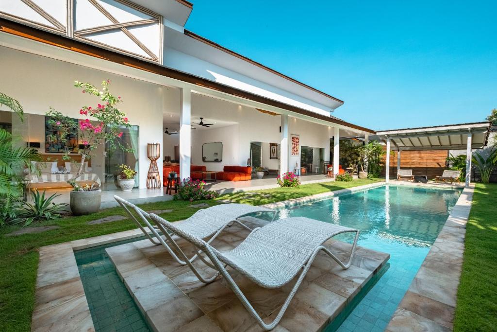a villa with a swimming pool and a house at Bingin Villas Luxury, Concierge and Security in Uluwatu