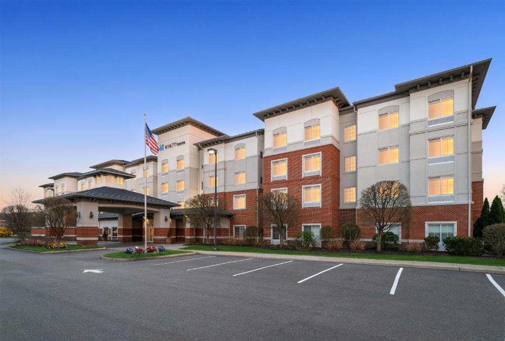 an exterior view of a hotel with a parking lot at Hyatt House Fishkill-Poughkeepsie in Fishkill