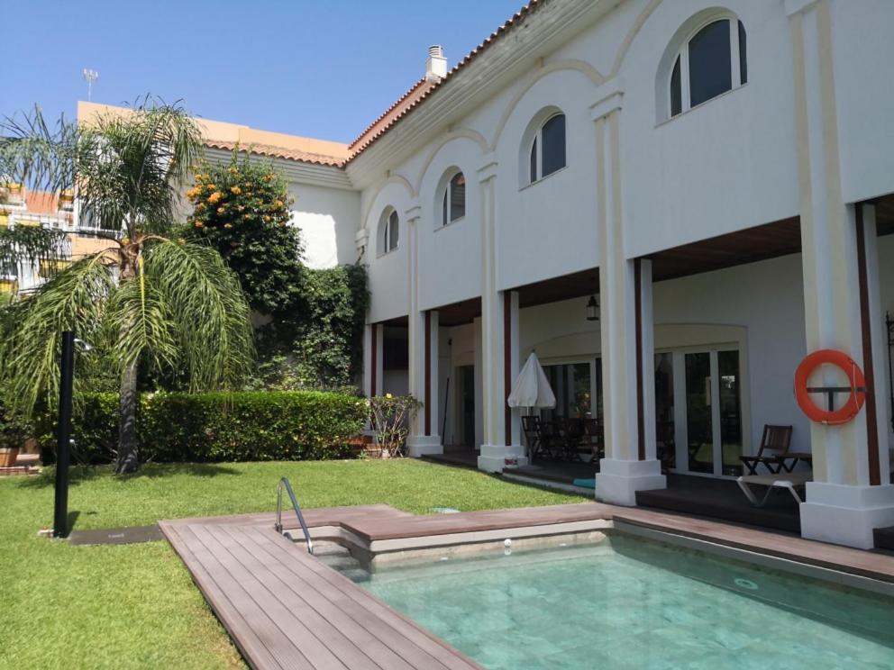 a house with a swimming pool in front of it at La Luna Blanca in Torremolinos